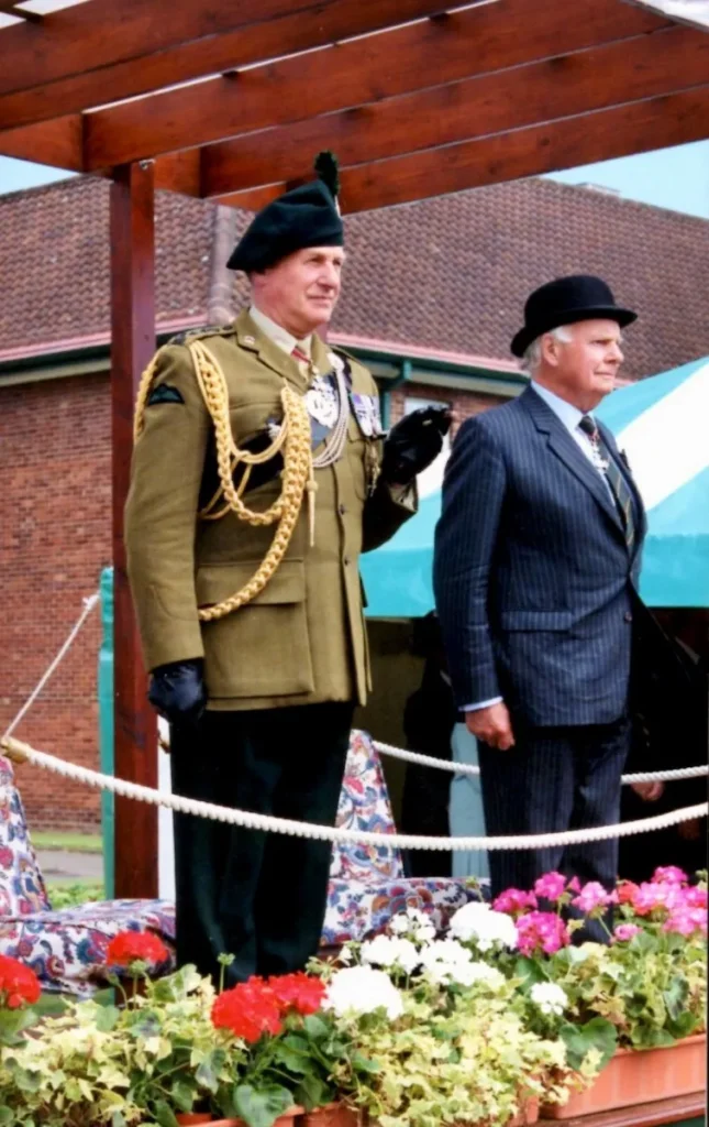 Colonel Sir Dennis Faulkner and General Sir Roger Wheeler review an Old Soldiers' Day Parade in Saint Patrick's Barracks, Ballymena